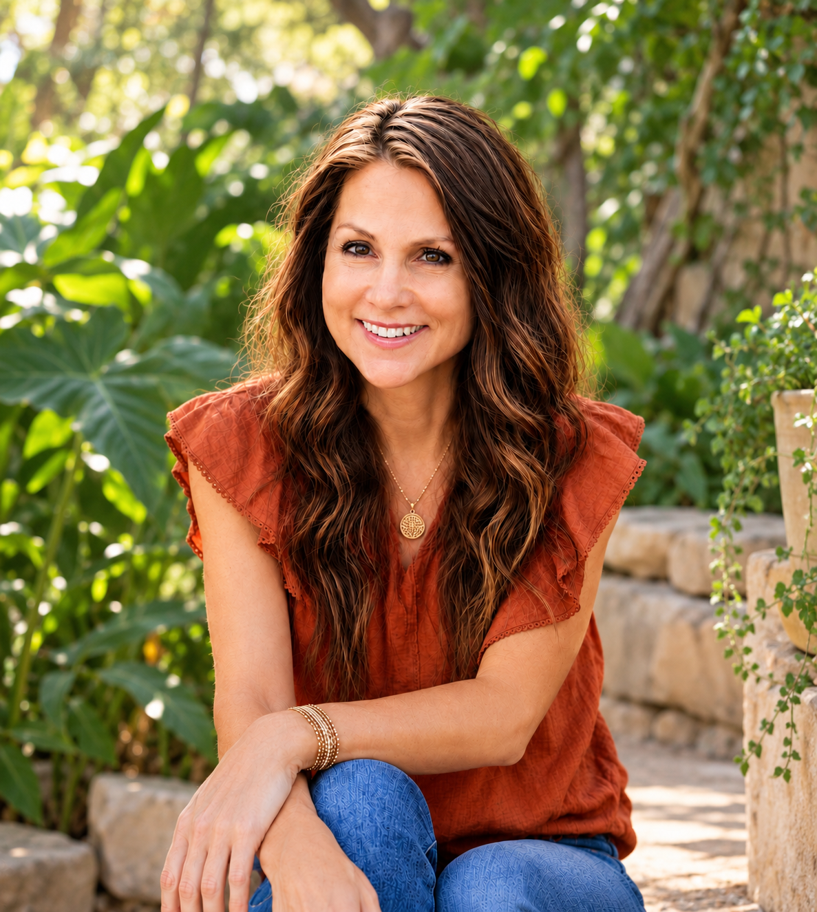 Christy smiling in a lush, sunlit garden